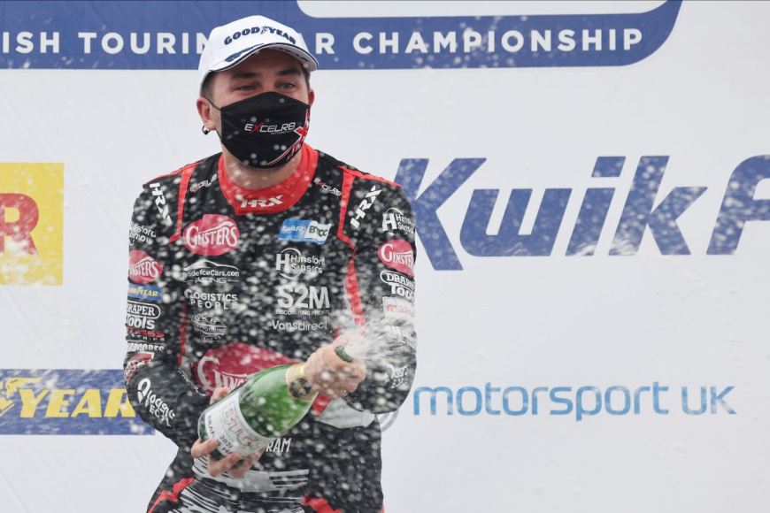 Tom Ingram spraying champagne at Brands Hatch